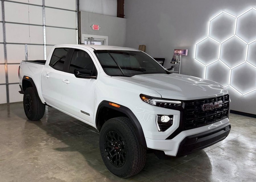 Lifted white GMC Canyon with off-road wheels at Garrett Tinting in Bryant, AR